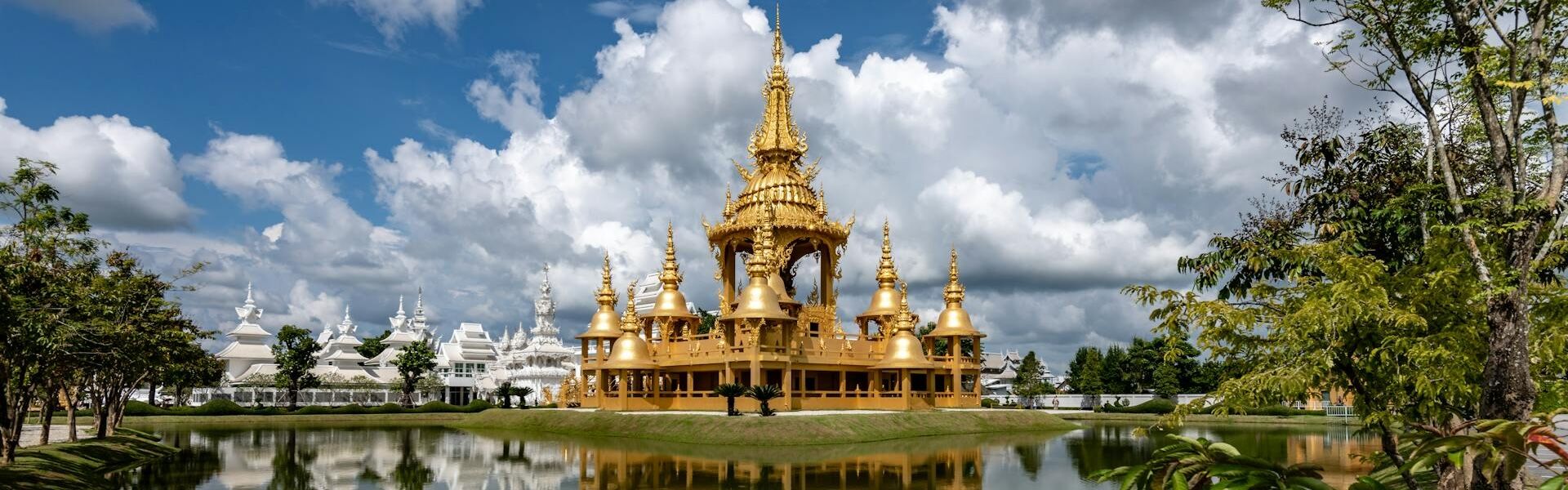 Golden White Temple of Chiang Rai on a scenic Chiang Rai Travel banner by Legend Travel Group.